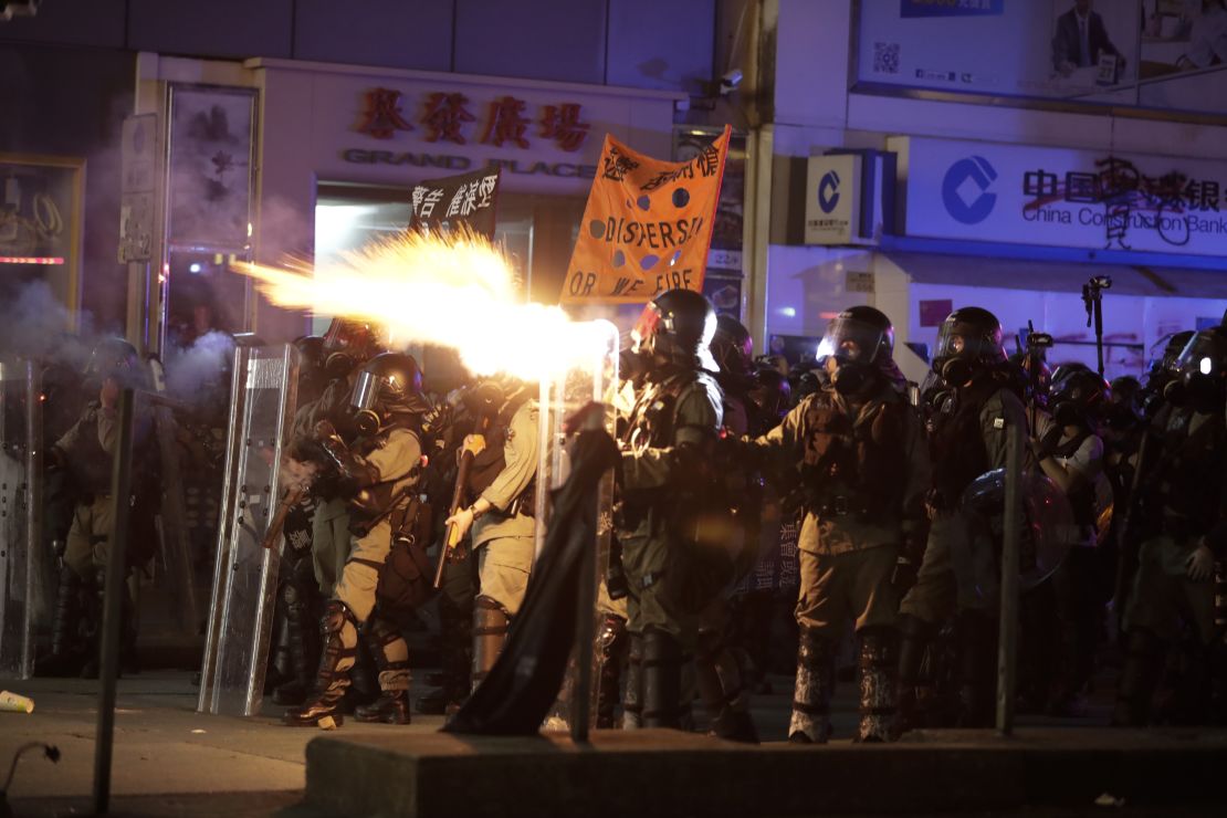 Police fire tear gas to disperse protestors in Hong Kong on Sunday.
