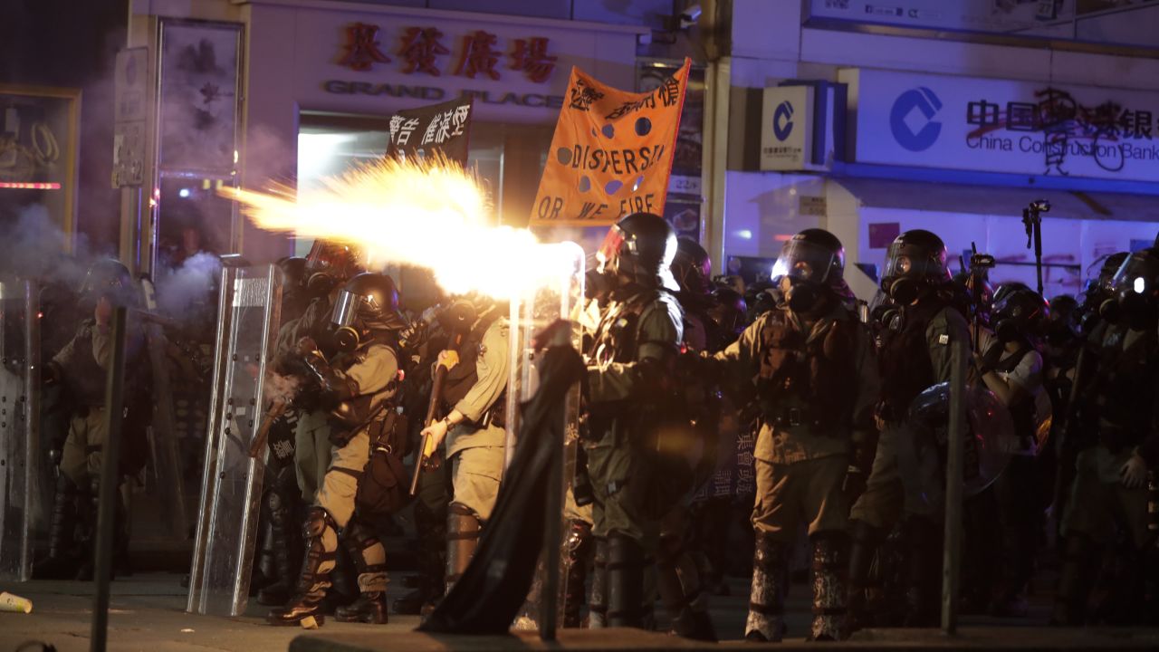 Police fire tear gas to disperse protestors in Hong Kong on Sunday.