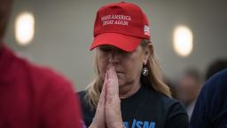 A supporter participates in a group prayer at the start of a campaign rally for Sen. Ted Cruz in October 2018 in Conroe, Texas. 