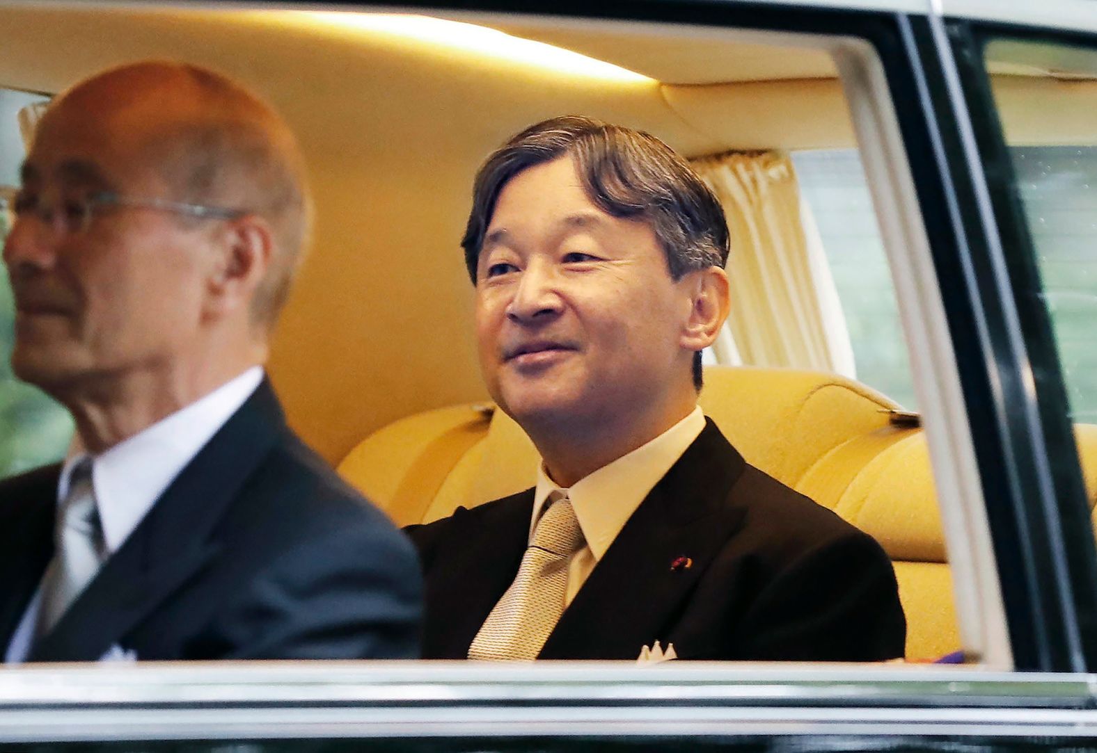 Japan's Emperor Naruhito smiles as he heads to the Imperial Palace in Tokyo on October 22.