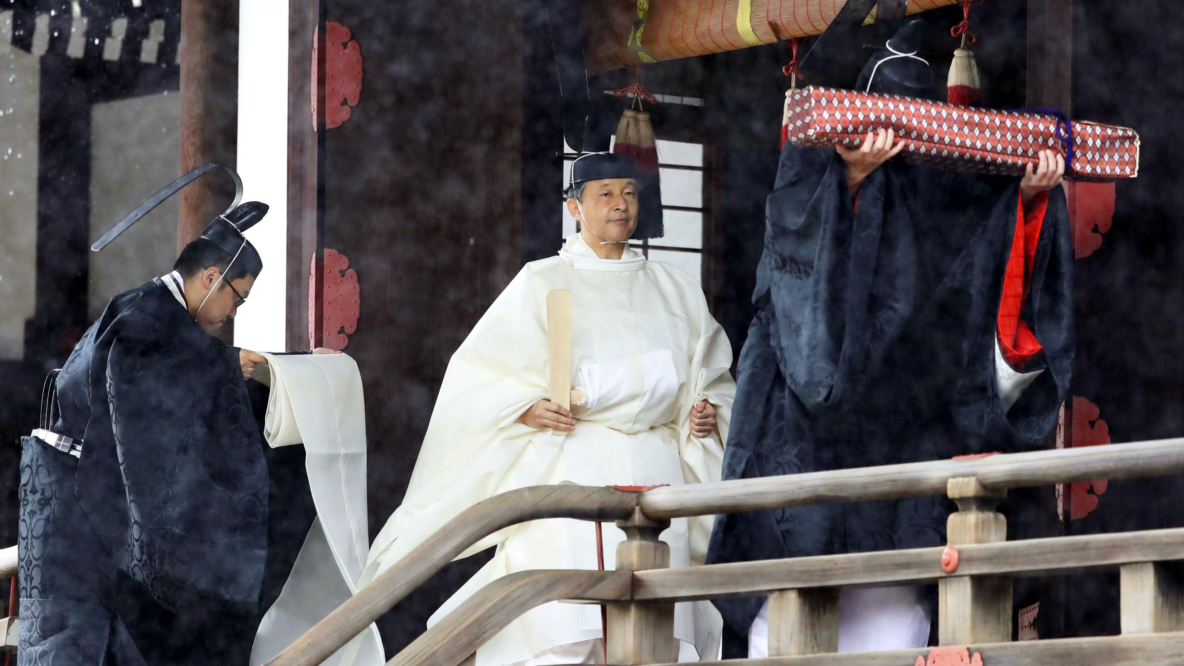 Japan's Emperor Naruhito, in a white robe, leaves after praying at Kashikodokoro.