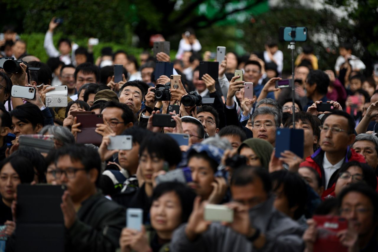 A crowd gathers to watch firing artilleries marking Japan's Emperor Naruhito's enthronement.