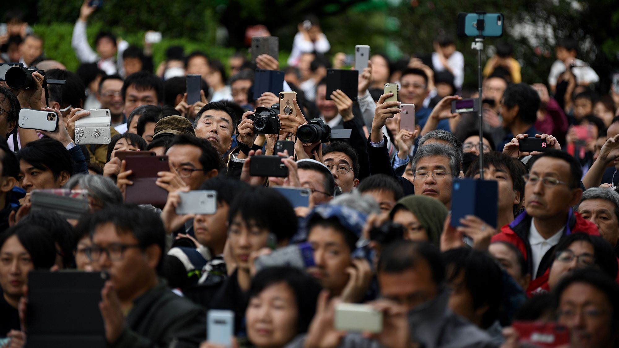 A crowd gathers to watch firing artilleries marking Japan's Emperor Naruhito's enthronement.