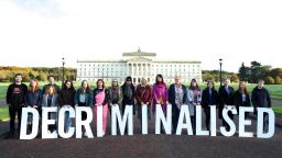 TOPSHOT - Pro-choice supporters pose as they gather at Parliament buildings on the Stormont Estate in Belfast on October 21, 2019, as some of Stormont's assembly members prepare to return to the chamber for the first time in nearly three years, after a petition triggered a recall. - A group of Northern Irish lawmakers will return to their parliament on October 21 in a last-minute protest at the liberalisation of abortion laws, set to come into force after being decided by London for the suspended Belfast executive. The regional government in Belfast collapsed in January 2017 after a scandal over a renewable heating scheme split the power-sharing executive, amid a breakdown in trust. Abortion is currently illegal in the province, except when the mother's life is in danger. (Photo by PAUL FAITH / AFP) (Photo by PAUL FAITH/AFP via Getty Images)