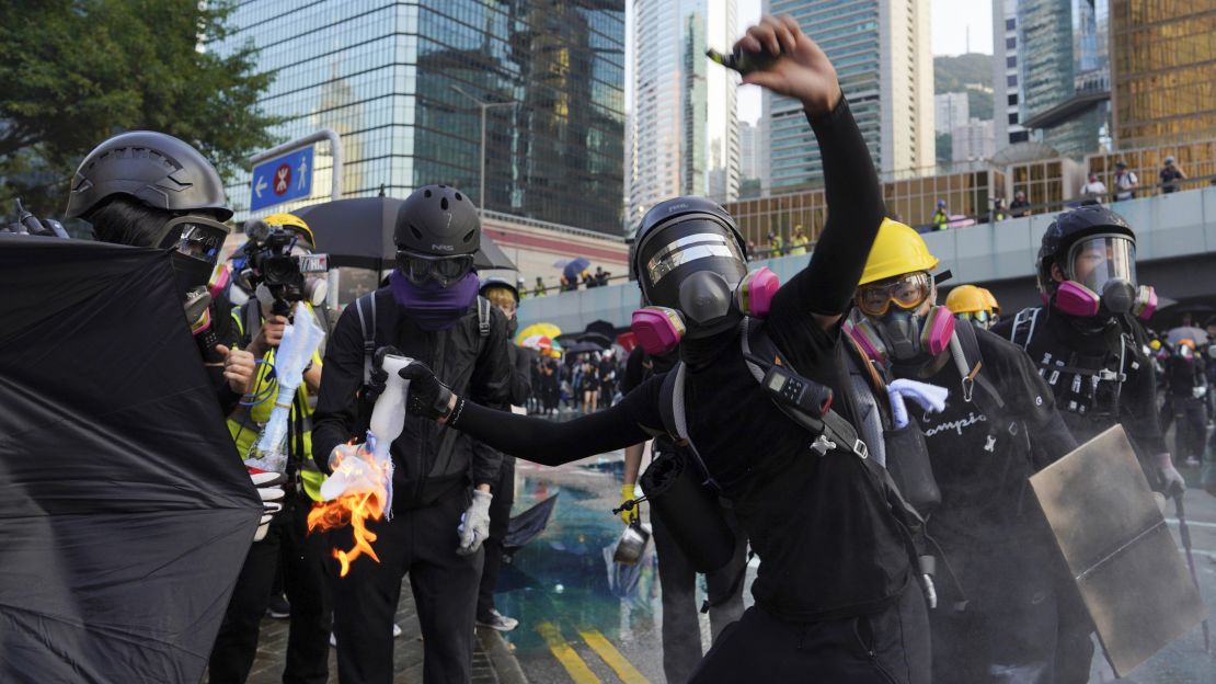 An anti-government protester throws a Molotov cocktail during a demonstration near Central Government Complex in Hong Kong, in September.