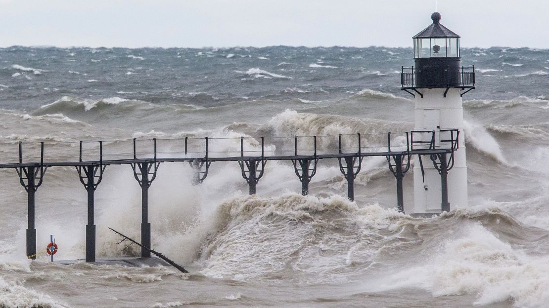 Large waves on Lake Michigan, caused by high winds, crash Wednesday into the St. Joseph Lighthouse and pier in St. Joseph, Michigan. 