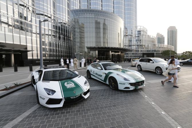 Lamborghini (L) and Ferrari police vehicles at the foot of the Burj Khalifa tower in Dubai. 