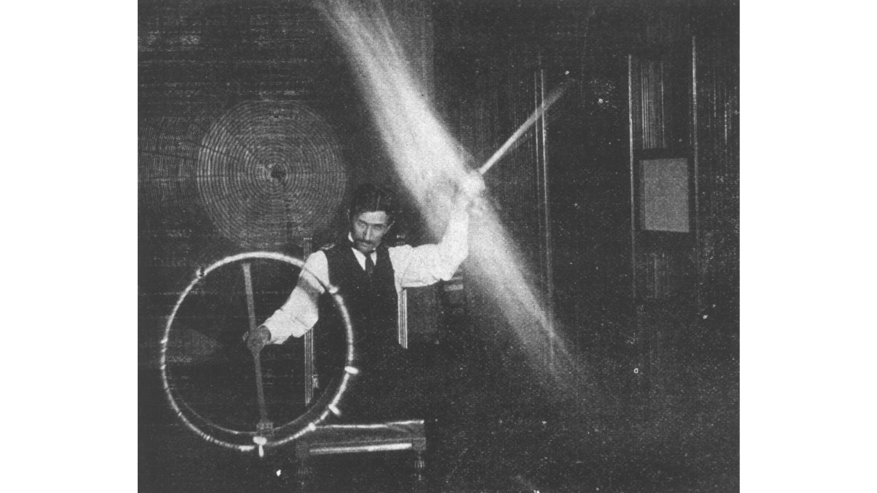 Nikola Tesla demonstrates an experiment  in his New York City lab in 1895.