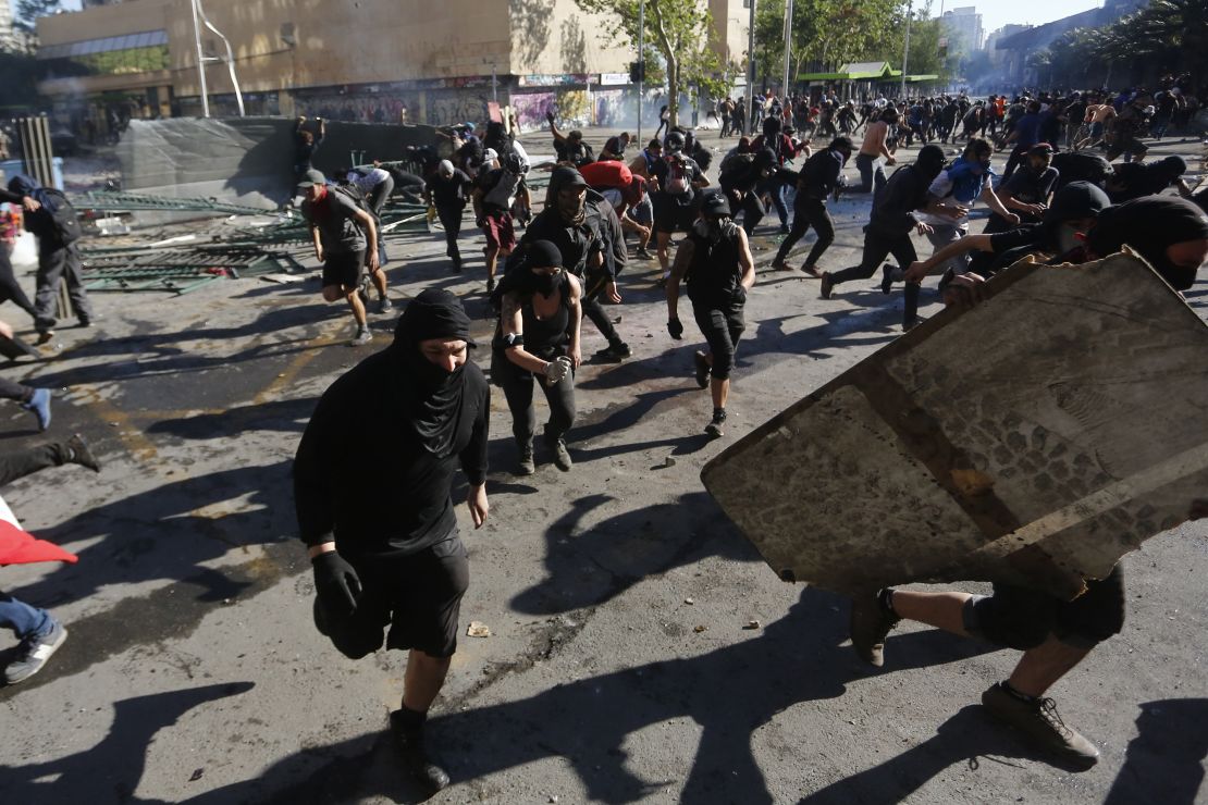 Demonstrators clash with riot police in Santiago, Chile. 