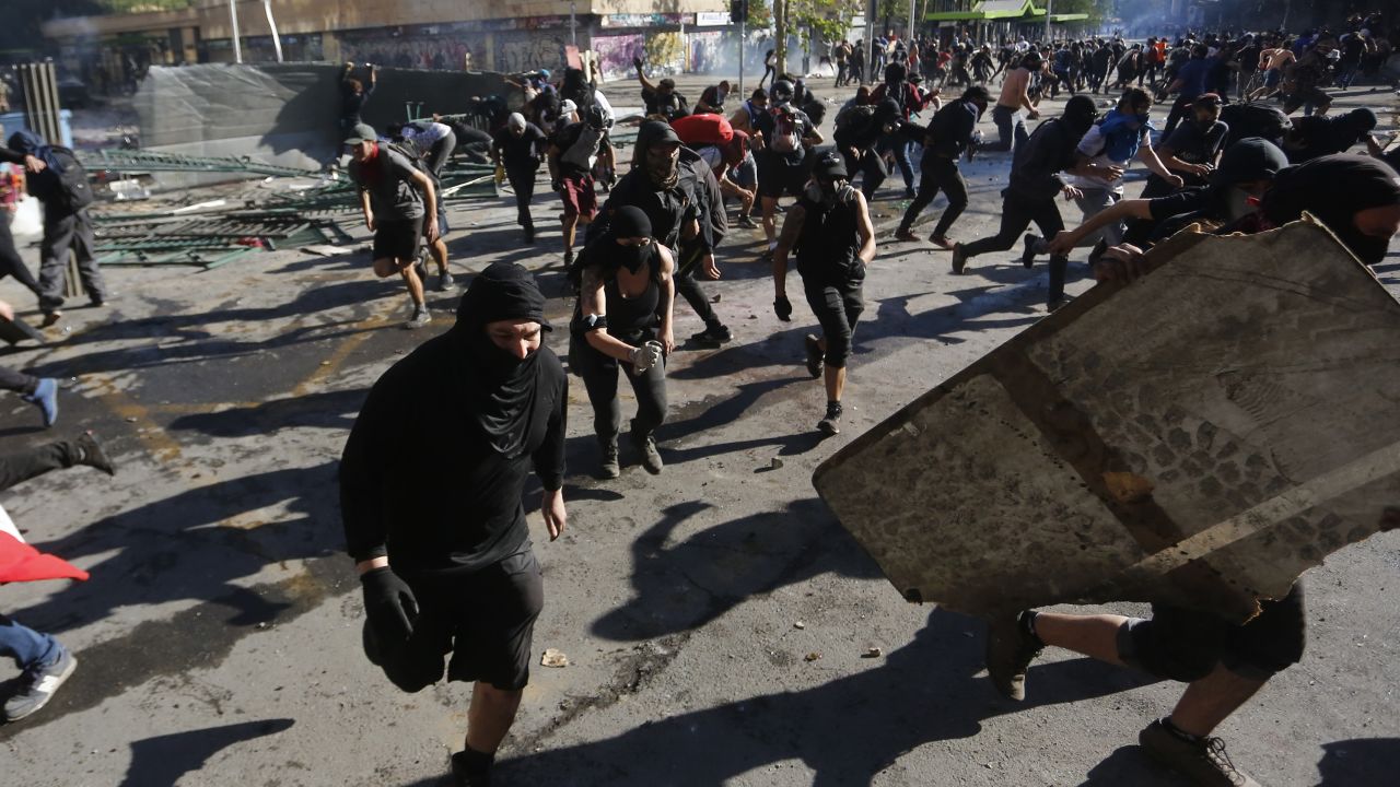 Demonstrators clash with riot police in Santiago, Chile. 