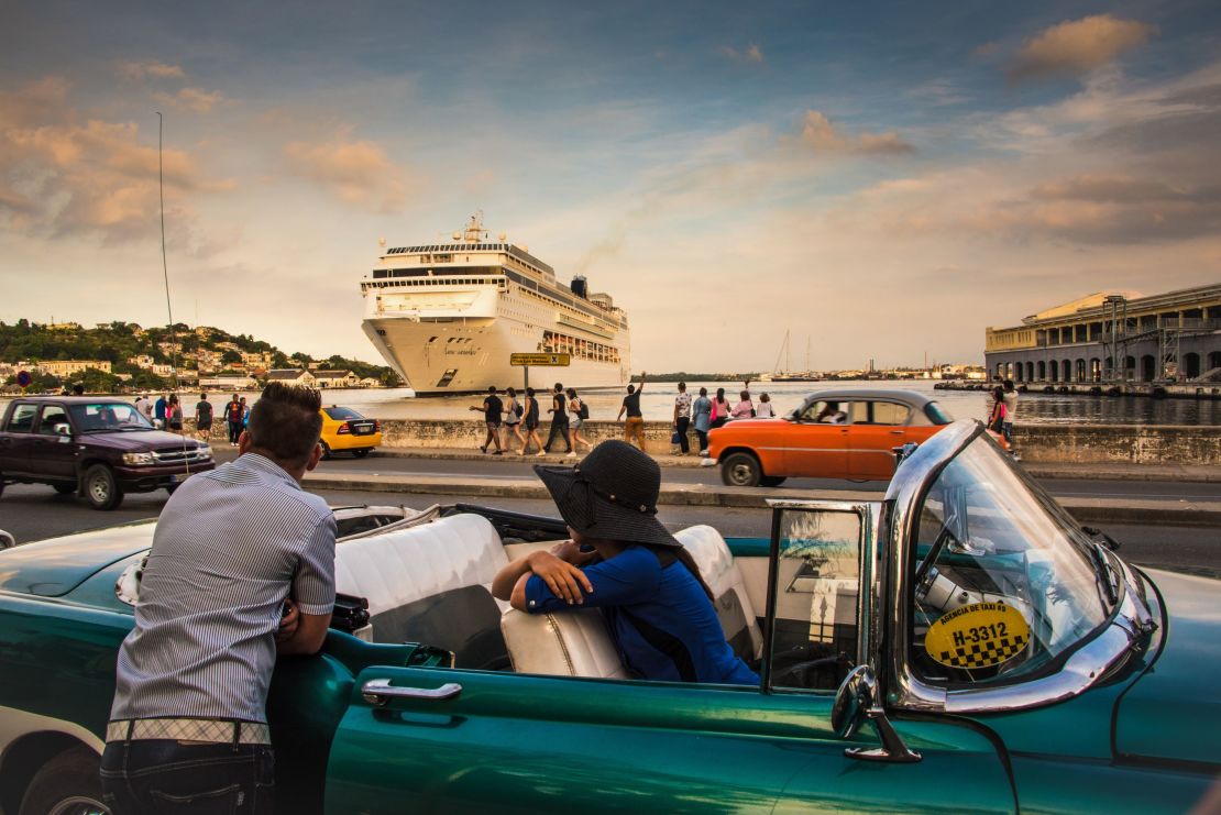 Cubans observe the arrival of a cruise ship bringing tourists to Havana in 2017. 