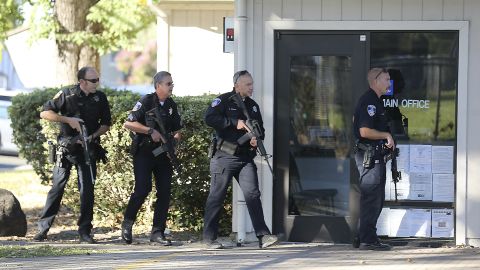 Police officers search for a suspect in the shooting near Ridgway High School in Santa Rosa, California. 