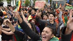 Supporters of Bolivia's main opposition presidential candidate, former president (2003-2005) Carlos Mesa, shout slogans against supporters of president and candidate Evo Morales, as both groups gather outside the hotel where the Supreme Electoral Tribunal has its headquarters to count the election votes, in La Paz, on October 21, 2019. - Evo Morales, seeking a controversial fourth term, led Bolivia's presidential election race Sunday but faces a historic second round run-off against Mesa, partial results showed. Morales had 45 percent of the vote to Mesa's 38 percent, the Supreme Electoral Tribunal announced, with most of the votes counted. (Photo by Aizar RALDES / AFP) (Photo by AIZAR RALDES/AFP via Getty Images)