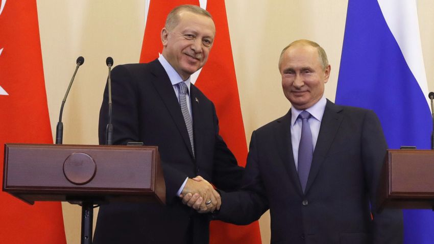 Russian President Vladimir Putin, right, and Turkish President Recep Tayyip Erdogan shake hands after a joint news conference after their talks in the Bocharov Ruchei residence in the Black Sea resort of Sochi, Russia, Tuesday, Oct. 22, 2019. Erdogan says Turkey and Russia have reached a deal in which Syrian Kurdish fighters will move 30 kilometers (18 miles) away from a border area in northeast Syria within 150 hours. (Turkish Presidential Press Service/Pool Photo via AP)