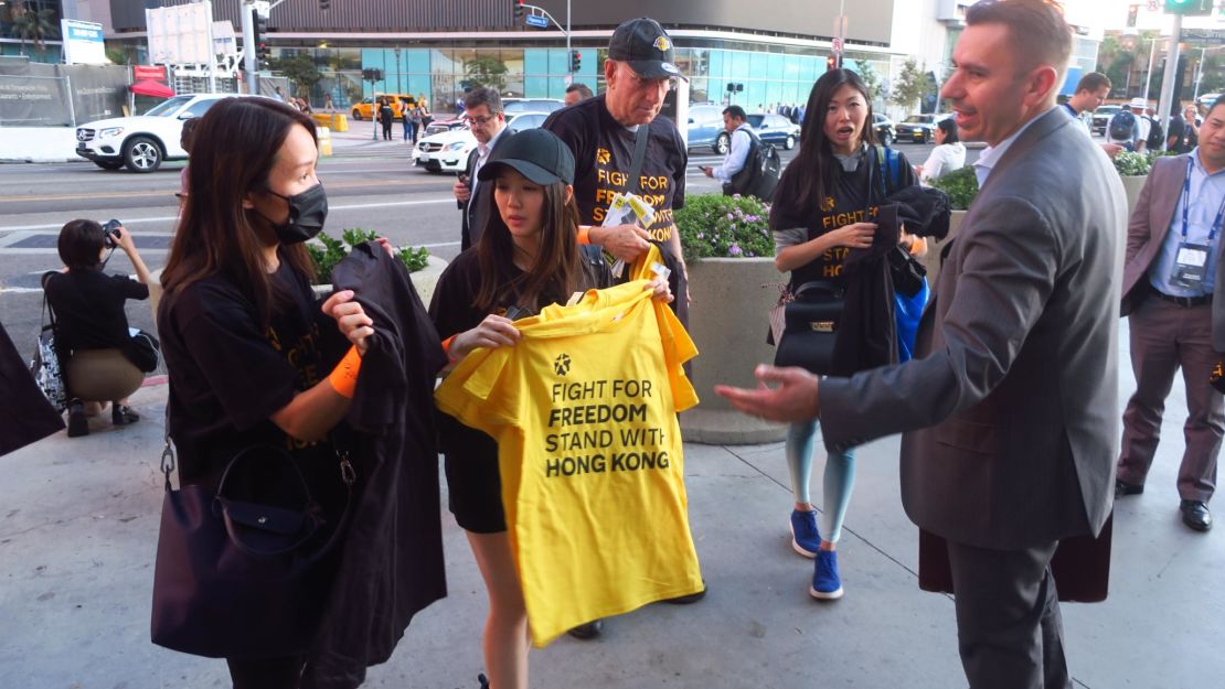 Fans entering the Staples Center arena to watch the opening night game grabbed T-shirts in yellow and black. 