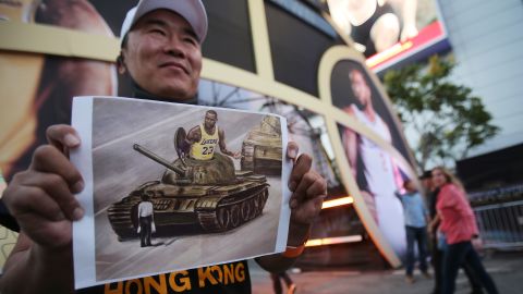  A pro-Hong Kong activist holds an image depicting LeBron James aboard a Chinese tank in Tiananmen Square before the Los Angeles Lakers season opening game against the against the LA Clippers outside Staples Center on October 22, 2019.