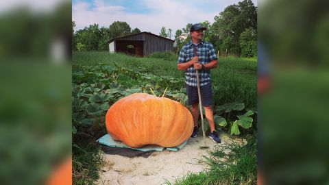 Justin Ownby standing next to his giant pumpkin.