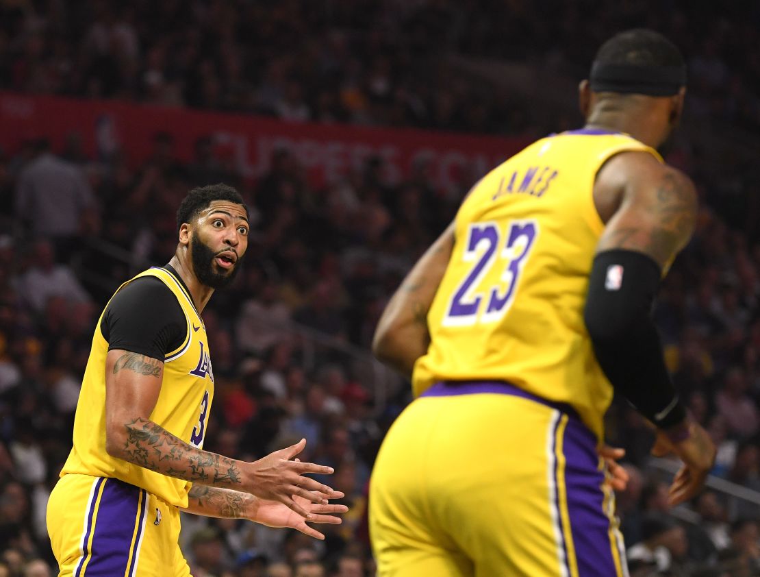 Newly aquired  Anthony Davis (left) of the Los Angeles Lakers interacted with teammate LeBron James during the first half of the game. 