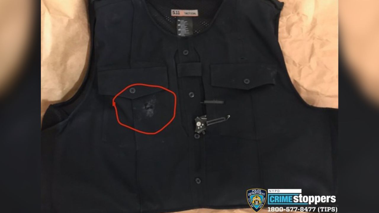 Authorities display a damaged bullet-proof vest that likely saved the life of an NYPD officer in an overnight shooting.