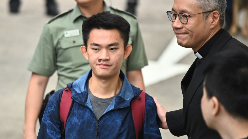 Chan Tong-kai (L), 20, wanted in Taiwan for the murder of his pregnant girlfriend during a holiday the two Hong Kongers took there in 2018, is greeted by Reverend Peter Koon Ho-ming (R) as he walks out the Pik Uk Prison in Hong Kong on October 23, 2019, after serving a short jail sentence for stealing his girlfriend's possessions. - Chan's case, where he fled back to Hong Kong where Taiwanese police were unable to apprehend him because there is no extradition agreement between the two territories, triggered an ill-fated proposal by Hong Kong's pro-Beijing government to ram through a sweeping extradition bill, which would have allowed the city to extradite suspects to any territory including the authoritarian mainland. (Photo by Philip FONG / AFP) (Photo by PHILIP FONG/AFP via Getty Images)