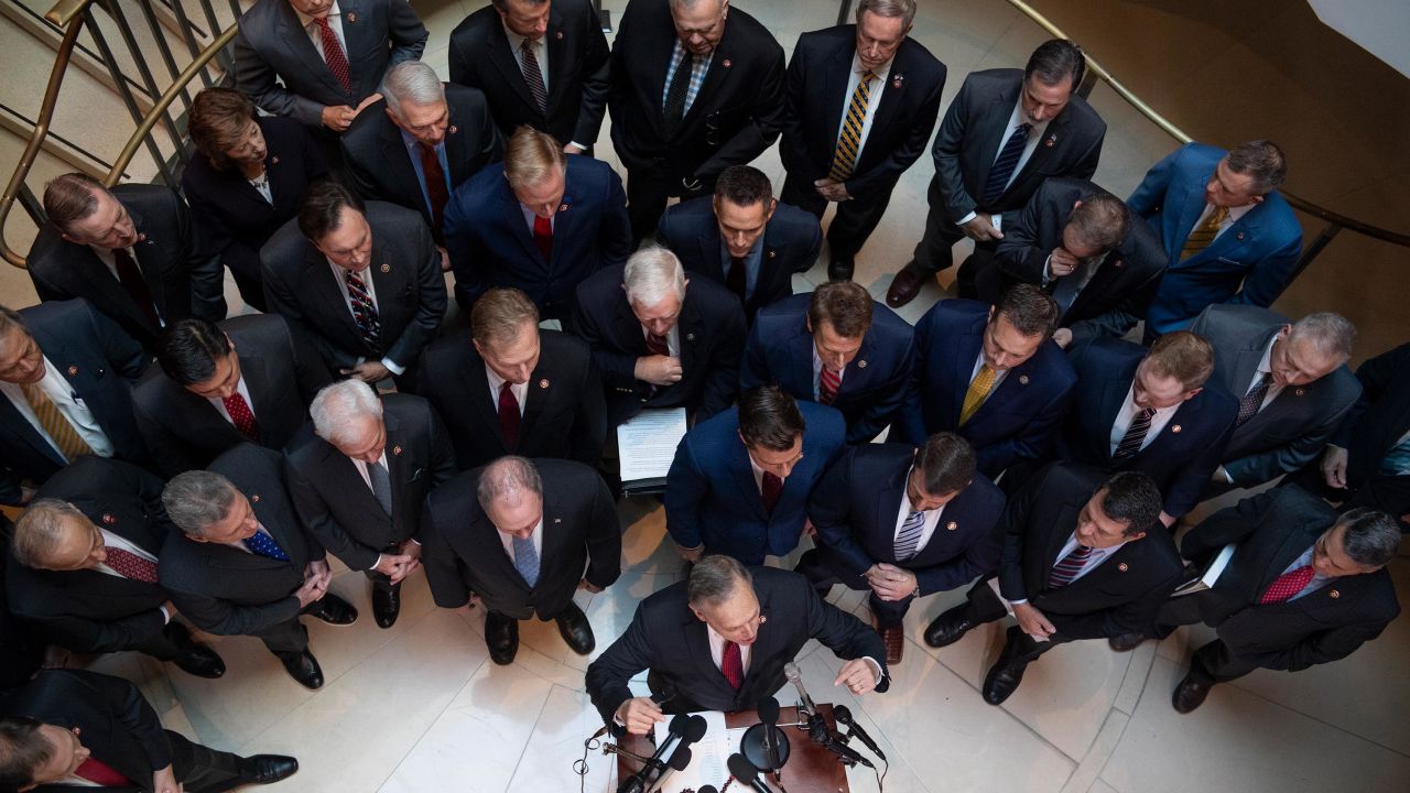 Republican Rep. Andy Biggs of Arizona speaks at the podium during a news conference on Capitol Hill outside the closed-door deposition related to the House's impeachment inquiry on Wednesday.