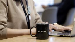 A branded mug sits on a table inside the WeWork Ocean Gate Minatomirai co-working office space, operated by The We Company, in Yokohama, Japan, on Friday, Oct. 11, 2019. WeWork formally withdrew the prospectus for an IPO this month, capping a botched fundraising effort that cost its top executive his job. The defeat places urgency on WeWork to find new sources of capital to keep its business running Photographer: Kiyoshi Ota/Bloomberg via Getty Images