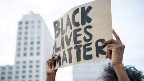 A protester holds up a sign reading "Black Lives Matter" during a demonstration in Berlin, on July 10, 2016.