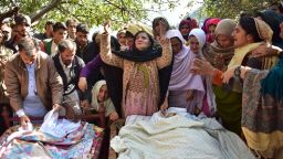 Relatives mourn next to bodies of victims of cross border shelling in Nousehri, a village in Neelum Valley, Pakistani-administered Kashmir, on October 20, 2019.