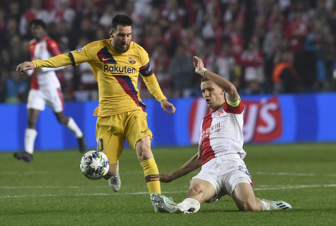 Slavia Prague's midfielder Tomas Soucek (R) vies for the ball with Barcelona's striker Lionel Messi during the Champions League clash.