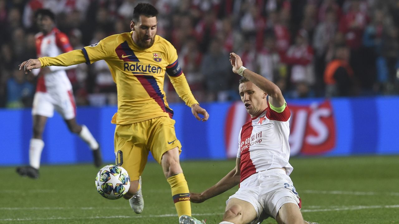Slavia Prague's midfielder Tomas Soucek (R) vies for the ball with Barcelona's striker Lionel Messi during the Champions League clash.