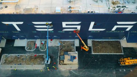 Workers on cranes installing a logo at the Tesla Gigafactory 3 earlier this month in Shanghai.