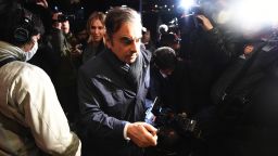 TOPSHOT - Former Nissan Chairman Carlos Ghosn (C) and his wife Carole (back centre L) are surrounded by members of the press as they arrive at their residence in Tokyo on April 3, 2019. - Tokyo prosecutors are considering pressing a fresh charge against Carlos Ghosn, local media said on April 3 as the former Nissan boss announced on Twitter he would be giving his side of the story. (Photo by CHARLY TRIBALLEAU / AFP)        (Photo credit should read CHARLY TRIBALLEAU/AFP/Getty Images)