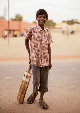 A boy with cricket bat on a street in Jaipur, Rajasthan. 