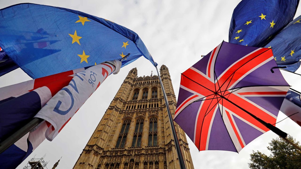 EU flag and Union flag-themed umbrellas of Brexit activists fly outside the Houses of Parliament in London on October 23, 2019. - British Prime Minister Boris Johnson could pivot towards a general election as the EU mulls granting a Brexit deadline extension on Wednesday, after a fresh twist to the divorce saga cast doubt over his hopes of leaving on October 31. In tense parliamentary votes on Tuesday, Johnson won initial backing for the divorce deal he agreed with the EU -- but MPs then rejected his timetable to rush it through parliament in a matter of days. (Photo by Tolga Akmen / AFP) (Photo by TOLGA AKMEN/AFP via Getty Images)