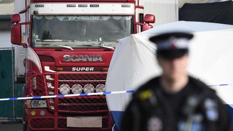 Police stand guard at the site where 39 bodies were discovered in the back of a lorry.