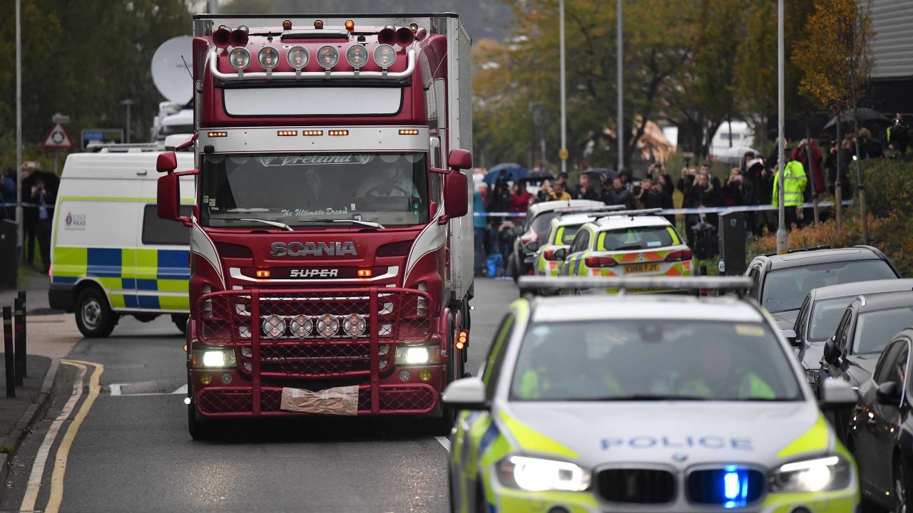 Police officers drive away a lorry (C) in which 39 dead bodies were discovered sparking a murder investigation at Waterglade Industrial Park in Grays, east of London, on October 23, 2019. - British police said 39 bodies were found near London Wednesday in the container of a truck thought to have come from Bulgaria. Essex Police said the people were all pronounced dead at the scene in an industrial park in Grays, east of London. Early indications suggest the victims are 38 adults and one teenager. A 25-year-old man from Northern Ireland has been arrested on suspicion of murder. (Photo by Ben STANSALL / AFP) (Photo by BEN STANSALL/AFP via Getty Images)