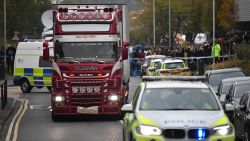 Police officers drive away a lorry (C) in which 39 dead bodies were discovered sparking a murder investigation at Waterglade Industrial Park in Grays, east of London, on October 23, 2019. - British police said 39 bodies were found near London Wednesday in the container of a truck thought to have come from Bulgaria. Essex Police said the people were all pronounced dead at the scene in an industrial park in Grays, east of London. Early indications suggest the victims are 38 adults and one teenager. A 25-year-old man from Northern Ireland has been arrested on suspicion of murder. (Photo by Ben STANSALL / AFP) (Photo by BEN STANSALL/AFP via Getty Images)