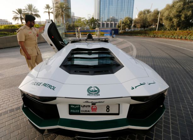 A police officer opens the door of a Lamborghini Aventador, near the Burj Khalifa in Dubai.<br /><br />Among the fastest of the supercars, the Aventador has a top speed of around 218 mph. Prices start at around $355,000. 