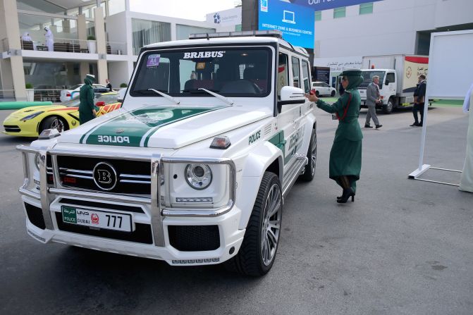  A female police officer locks her Mercedes Benz Brabus 4x4 supercar during the Dubai Airshow in November 2013. <br /><br />The heavyweight model has a top speed of 149 mph. 