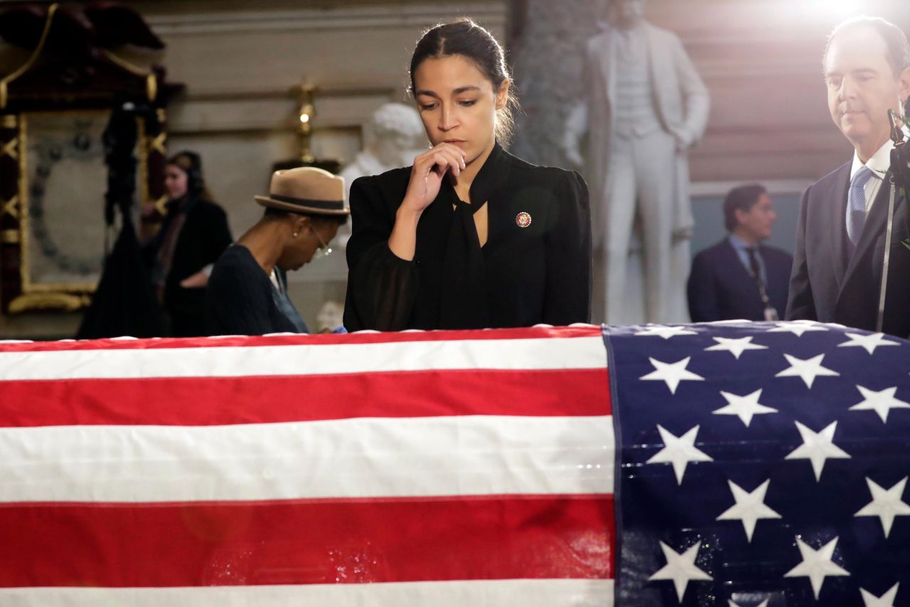 US Rep. Alexandria Ocasio-Cortez stops to pay her respects.