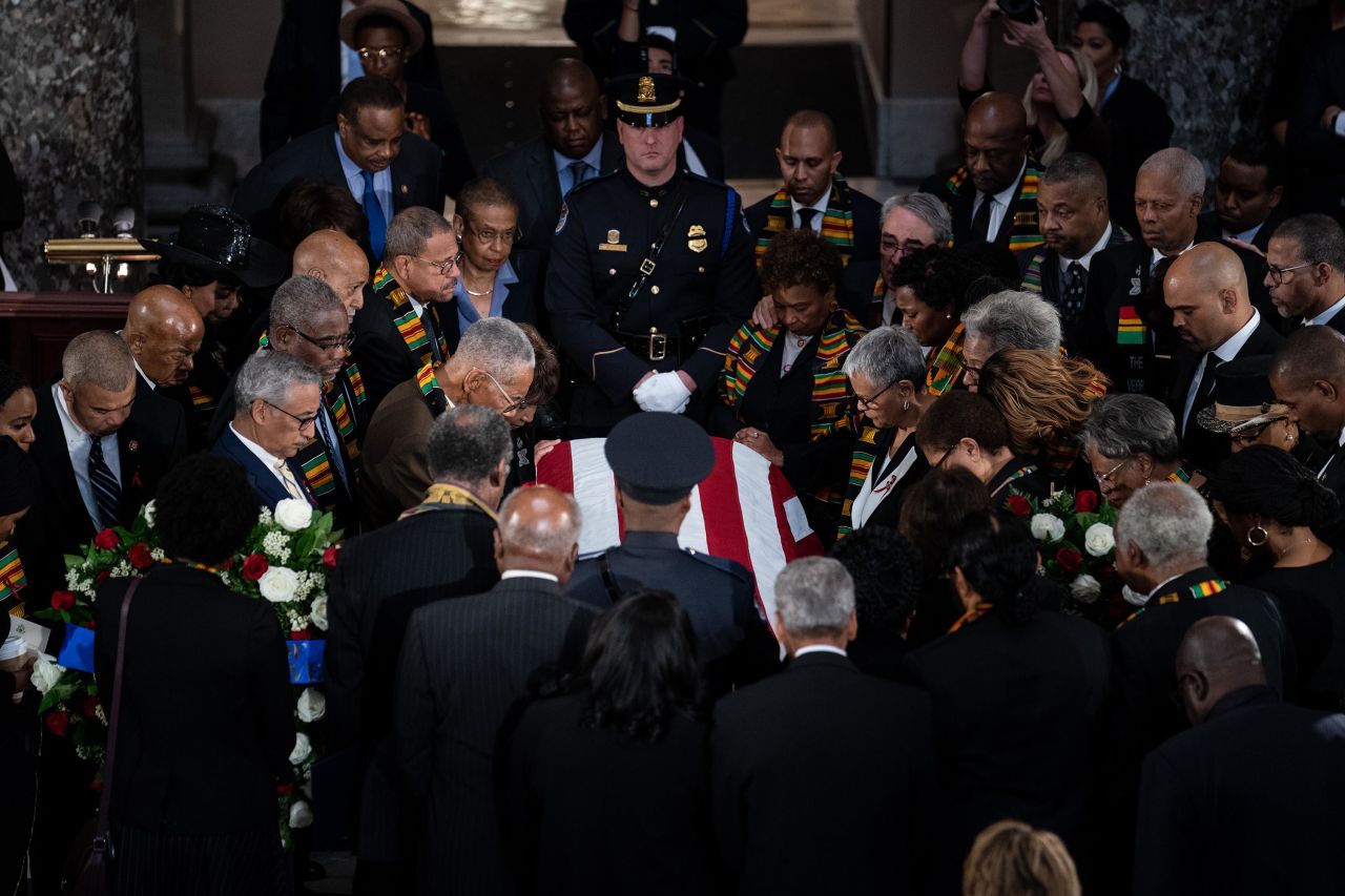 Members of the Congressional Black Caucus gather around the casket during Thursday's memorial service.