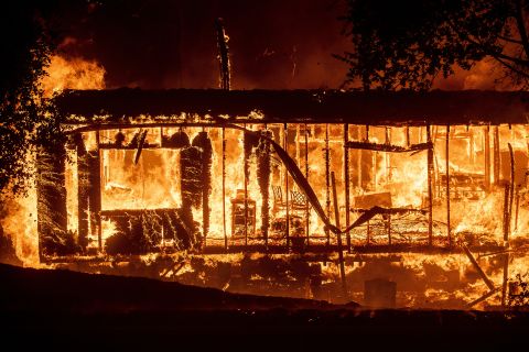 Flames consume a home in Jimtown, California, on October 24.