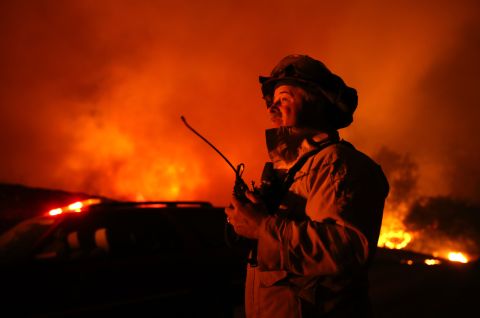 A firefighter monitors the Kincade Fire in Geyserville on October 24.