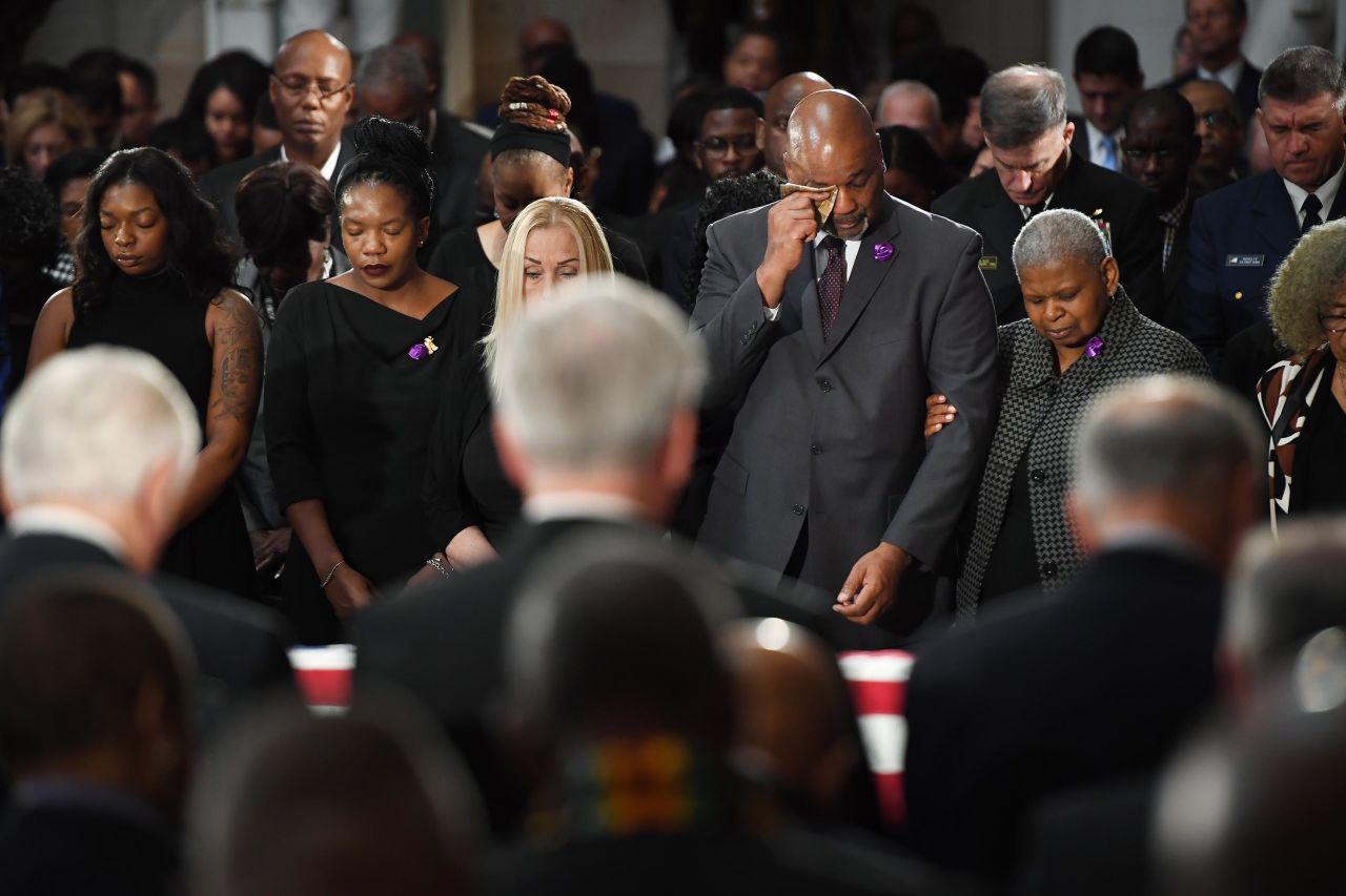 Family members mourn during the memorial service inside National Statuary Hall.