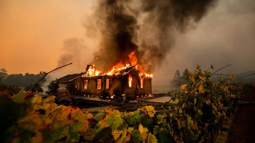 Vines surround a burning building as the Kincade Fire burns through the Jimtown community of unincorporated Sonoma County, Calif., on Thursday, Oct. 24, 2019. (AP Photo/Noah Berger)