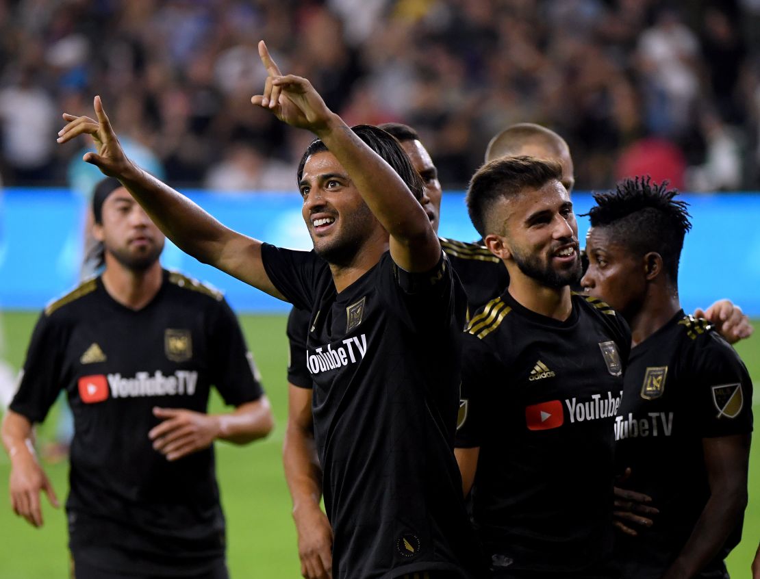 Carlos Vela (center) of LAFC celebrates his second goal against the LA Galaxy on Thursday in Los Angeles. The team's victory in the MLS Cup Playoffs was its first win against its inter-city rivals in six tries. 