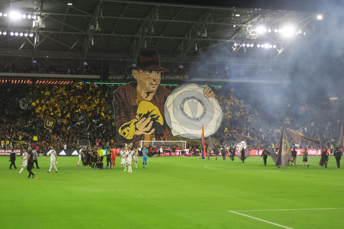 The North Stand at LAFC displays a banner depicting star forward Carlos Vela as Indiana Jones lifting the recently won MLS Supporter's Sheild. 