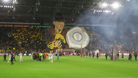 The North Stand at LAFC displays a banner depicting star forward Carlos Vela as Indiana Jones lifting the recently won MLS Supporter's Sheild.