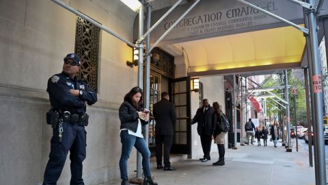 NYPD counterterrorism officer, far left, takes up station at Temple Emanu-El in October 2018, as religious institutions boost security in the aftermath of Pittsburgh's Synagogue shooting.