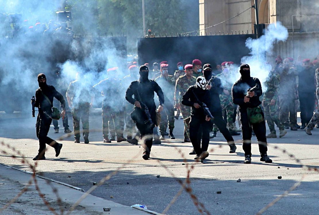 Security forces fire tear gas to disperse anti-government protesters in Baghdad.